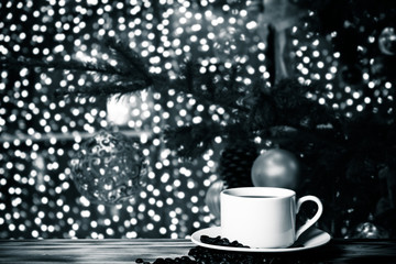 Coffee in a cup on wooden table opposite a defocused  background. Collage. Selective focus. Toned