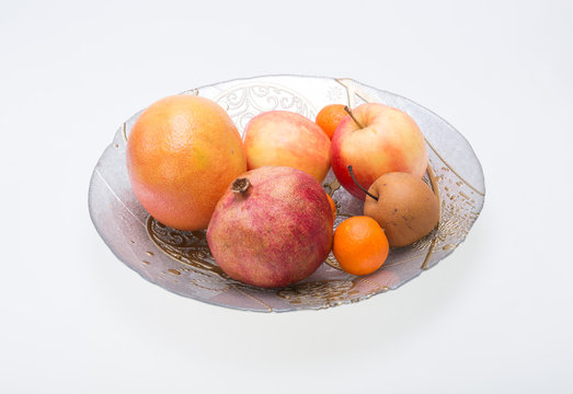 mix fresh fruits on plate isolated on white