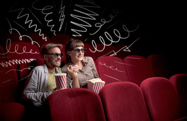 Cute couple in cinema watching movie