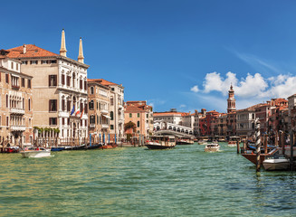 View of the Grand Canal, boats with tourists and the Rialto Bridge. Venice, Italy