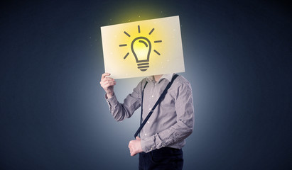 Businessman holding paper with lightbulb