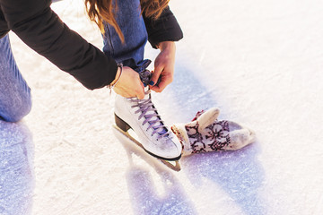 Girl in a new white skates for skating 