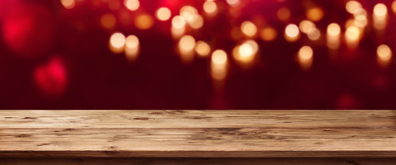 Red bokeh background with wooden table