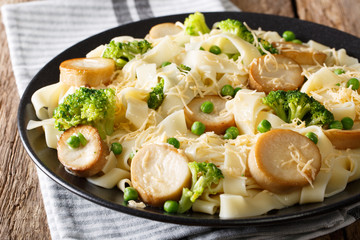 Fettuccine pasta with fried mushrooms, cheese and vegetables close-up. horizontal