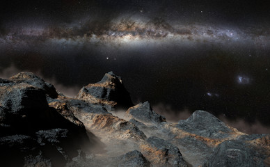 Fototapeta na wymiar rocky landscape with low crawling fog lit by the Milky Way