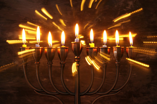 jewish holiday Hanukkah background with menorah (traditional candelabra) and burning candles