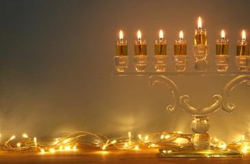 image of jewish holiday Hanukkah background with menorah (traditional candelabra) and candles.