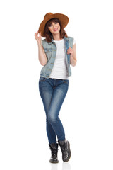 Cheerful Young Woman In Jeans Vest And Blue Suede Hat