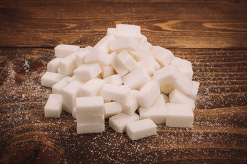 Bunch of white sugar cubes and granulated sugar