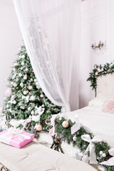 Fototapeta na wymiar Cozy Christmas home interior. New year decoration. bright bedroom room with large double bed.