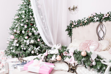Cozy Christmas home interior. focus on the tree. New year decoration. bright bedroom room with large double bed.