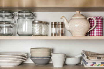 Different tableware on shelves
