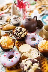 Variety of homemade pastry - donuts, muffins and bisquits on festive table