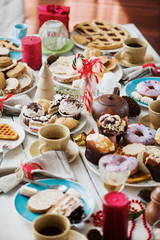 Homemade pastry and desserts on plates served on festive table for guests