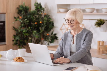 Modern senior woman using her laptop