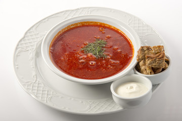 national cuisine borscht with sour cream and croutons on a white background