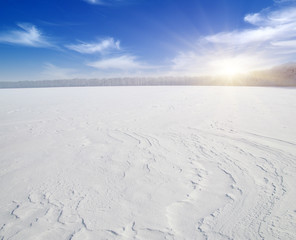 Fototapeta na wymiar Snowcovered fields on blue sky