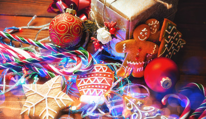 Christmas still life. homemade ginger biscuits, cane candy, on a wooden background.