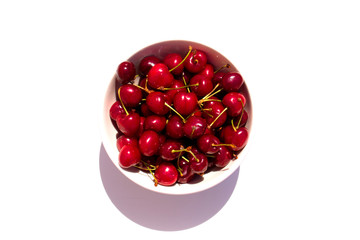 Cherry. Cherries in white bowl. Cherry on white background.