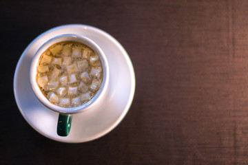 Coffee in cafe with marshmallow with blurred background.