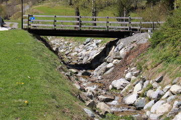 Fototapeta na wymiar A creek flowing down Alp mountains in Brand, Bludenz, Vorarlberg, Austria.