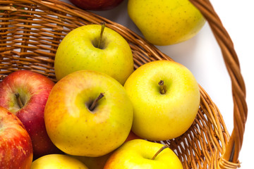 apples in a wicker basket on a white background.