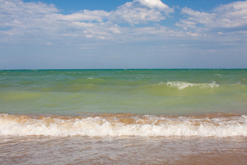 Adriatic Sea coast view. Seashore of Italy, summer sandy beach with clouds on horizon.