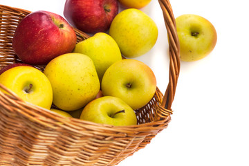 apples in a wicker basket on a white background.