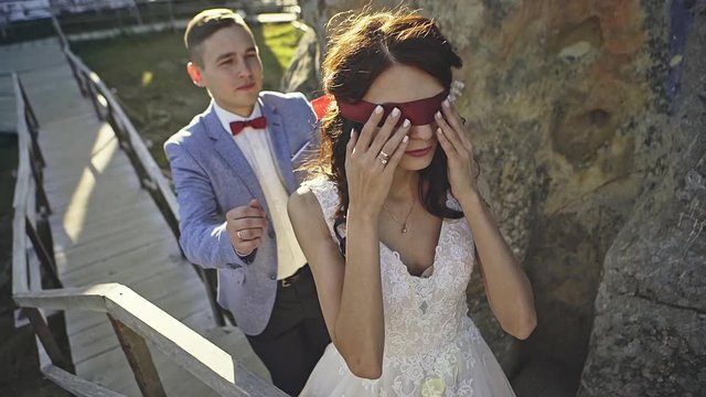 Blindfolded bride waiting for the groom