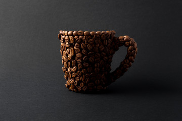 Coffee cup / Creative concept photo of a cup made of coffee on black background.