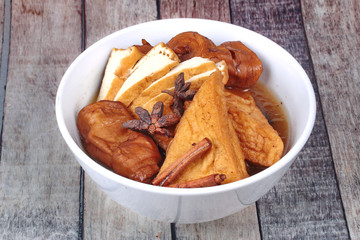 Chinese Vegetable festival  food as fried tofu and fermented flour in brown soup.