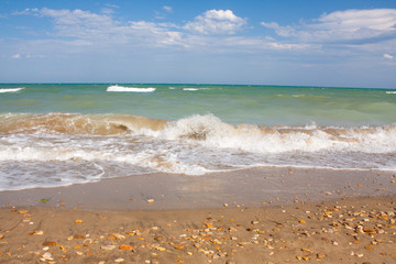 Adriatic Sea coast view. Seashore of Italy, summer sandy beach with clouds on horizon.