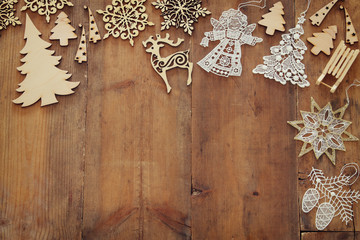 Top view image of christmas festive decorations on wooden background. Flat lay.