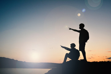 Silhouette man and girl backpacker on the top mountain , Relax time travel on holiday