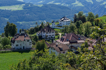 Fototapeta na wymiar Italian village in Alps mountain at sunny summer day. Soprabolzano, Oberbozen