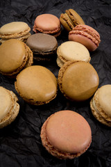 French macaroons cookies on black background.