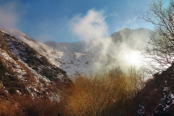 clouds in the mountains below peak level in winter in December