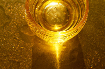 Golden texture with water drops. Thirst and its quenching