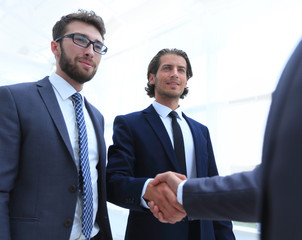 business group welcomes partner with a handshake