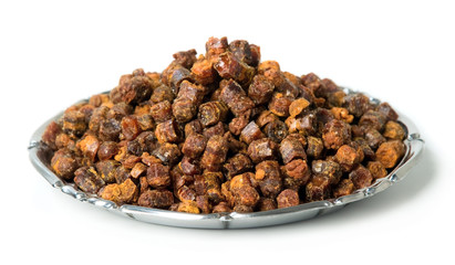 Propolis granules inside plate, bee product