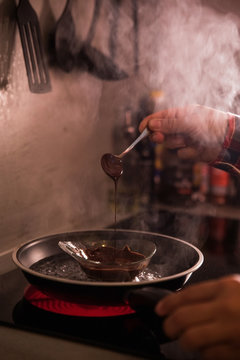 anonymous chef melting chocolate