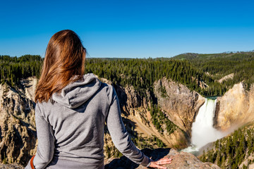 Tourist overlooking waterfall in Yellowstone