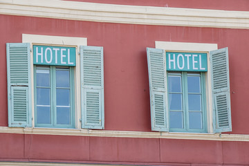 Fototapeta premium hotel signboard in a building facade with windows