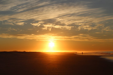 Fototapeta na wymiar Sunrise walk on beach