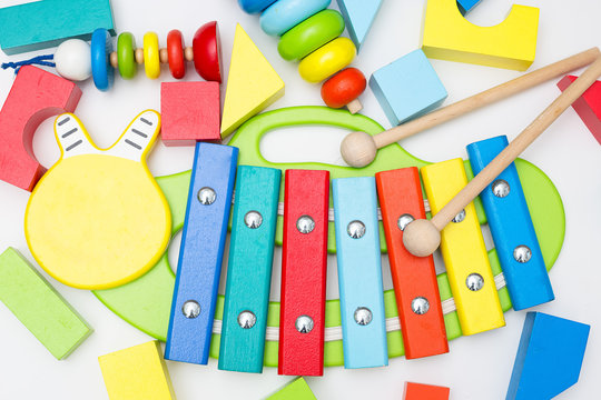 Xylophone and other wooden toys on a white background. flat lay