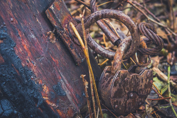 Old lock and rusty chain on a wooden boat