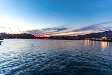 clouds turned pink and sky remained blue during the sunset time at city by the beach