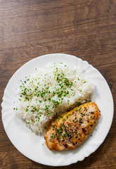 fried chicken breast with rice on a wooden background. with copy space. top view
