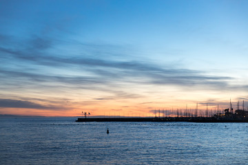 beautiful cloudy sky and colorful sunset view of the harbor