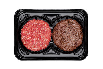 Raw and fried fresh beef burgers in plastic tray